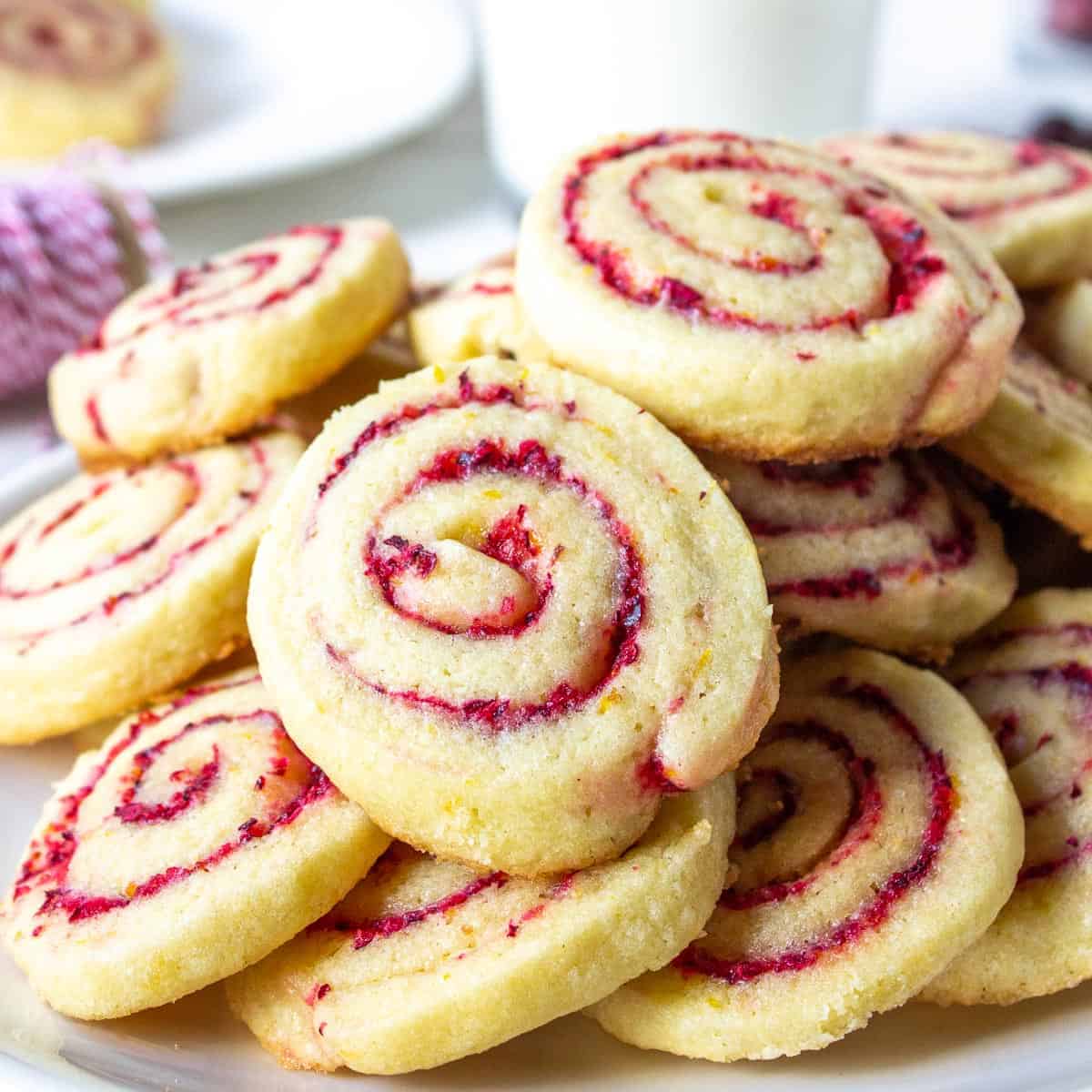 Cranberry orange cookies piled on a plate.