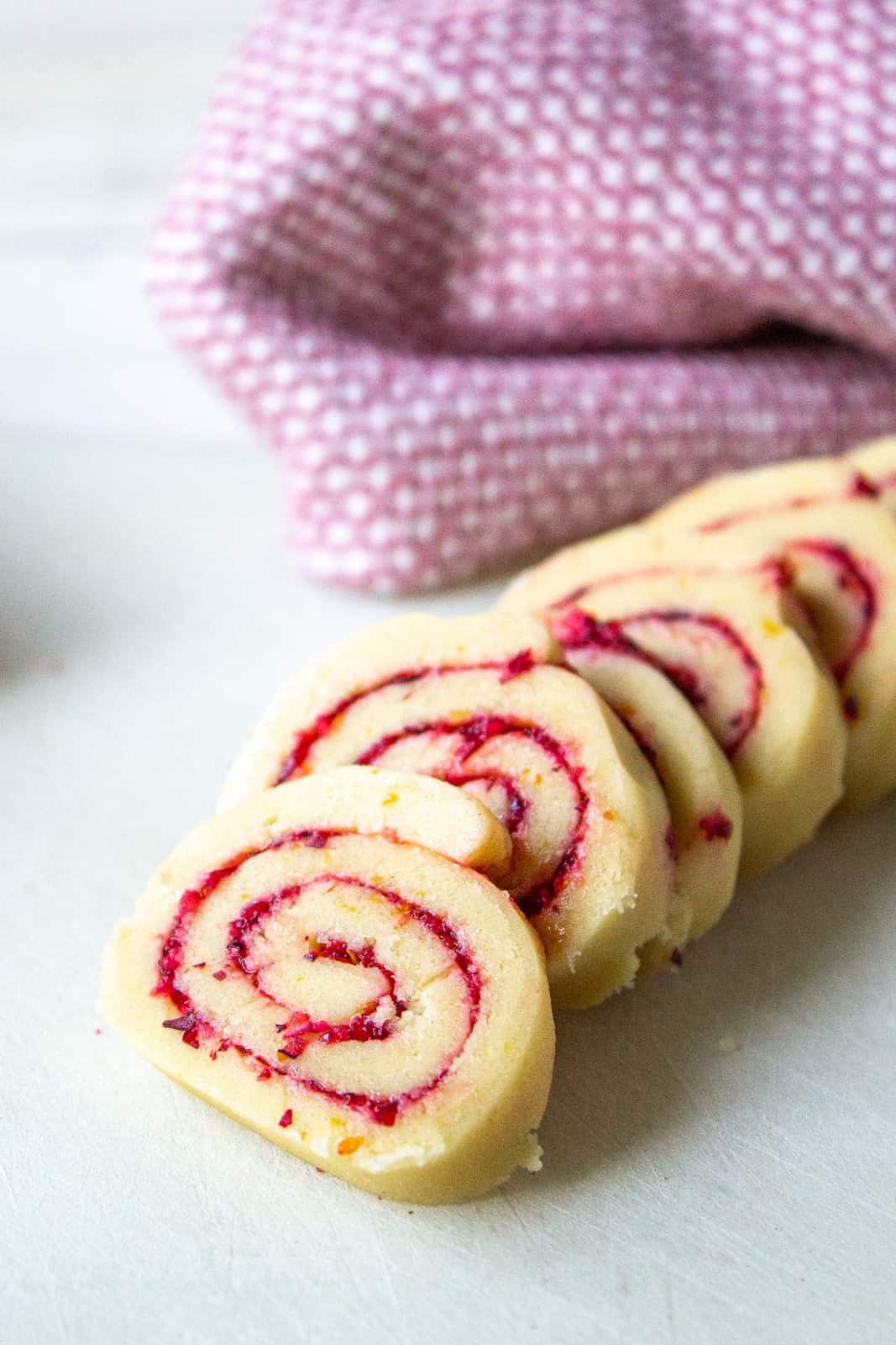 Slice swirled cookies on a white surface.