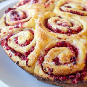 Sweet rolls with a cranberry filling on a white plate.