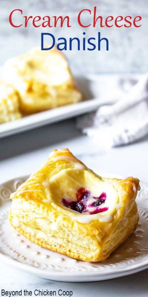 A puff pastry danish filled with a cheese mixture and berries.