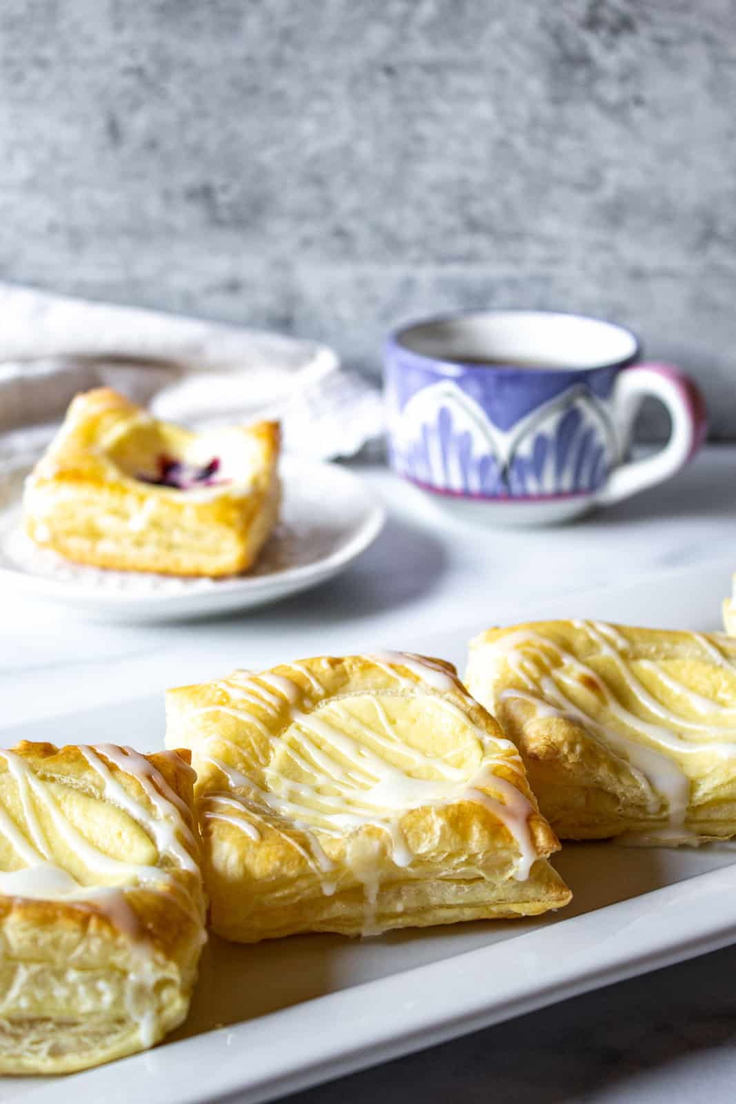 Cream cheese danishes on a white platter.