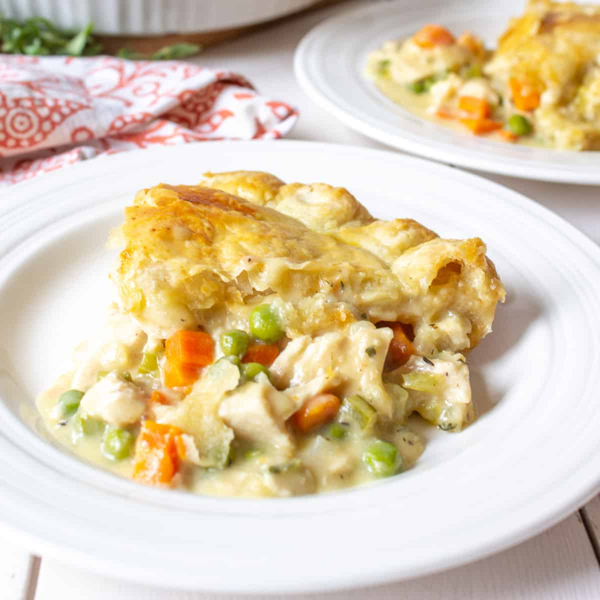 A serving of chicken pot pie on a small white plate.