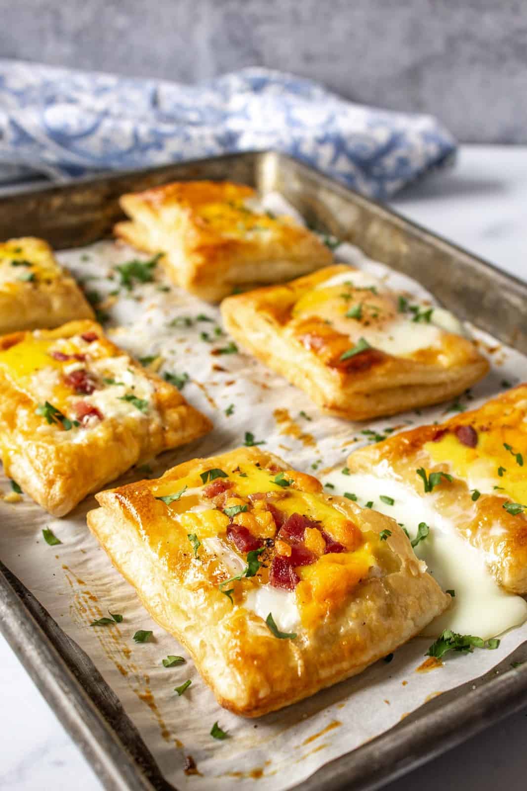 A baking sheet with puff pastry topped with baked eggs.