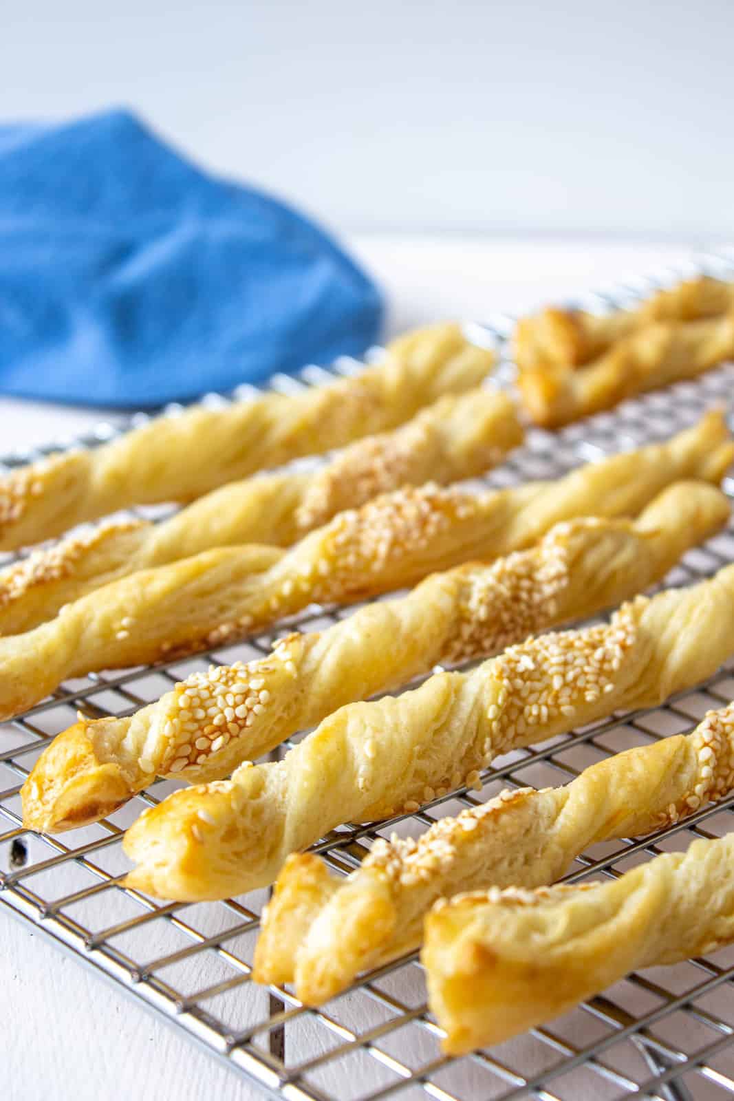 Twisted puff pastry strips topped with sesame seeds.
