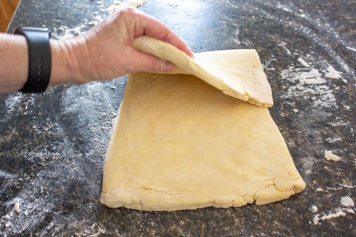 Folding puff pastry dough.
