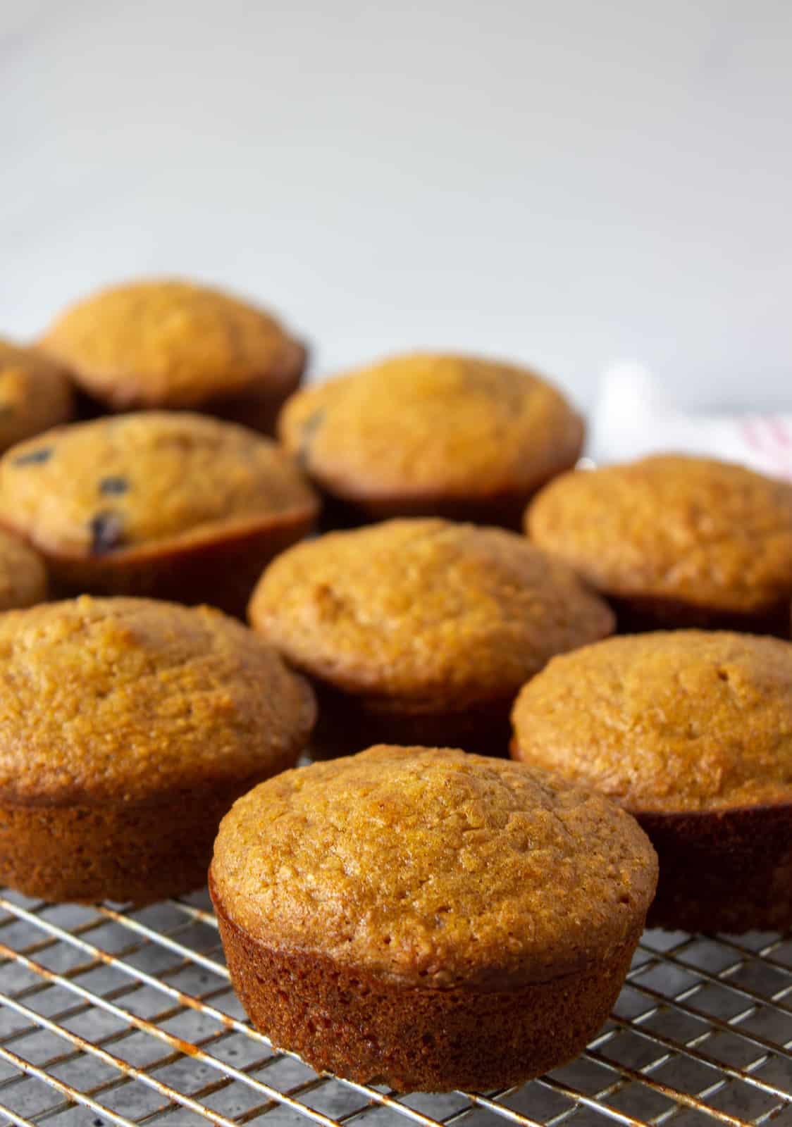 Bran muffins on a baking rack.