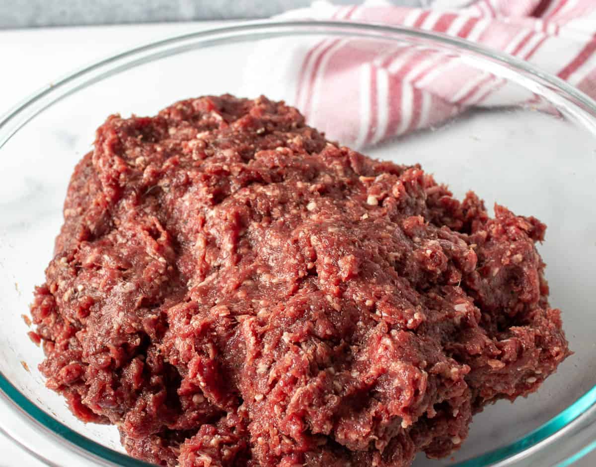 A glass bowl filled with ground venison.