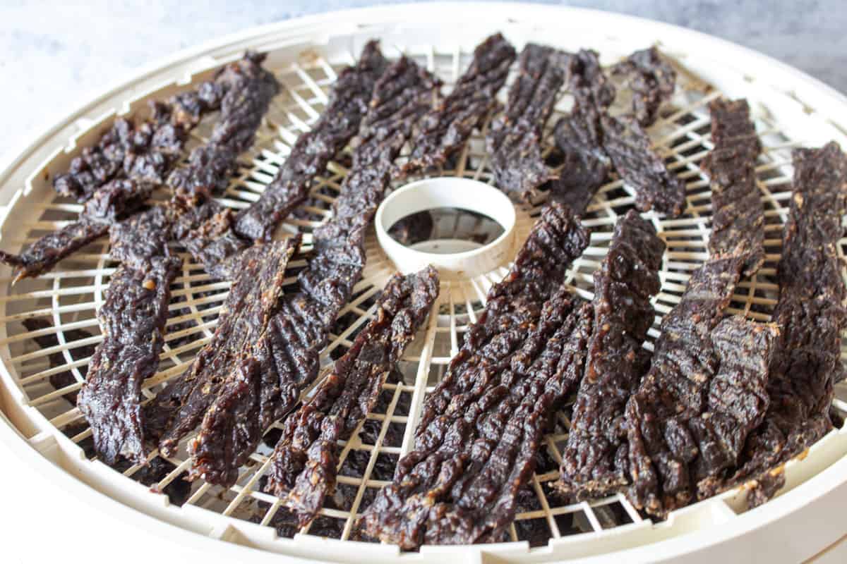 A dehydrator tray filled with wild game jerky.
