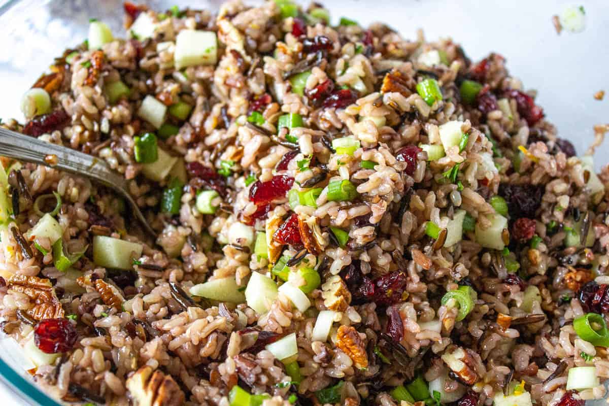 Wild rice with pecans and cried cranberries in a large bowl. 