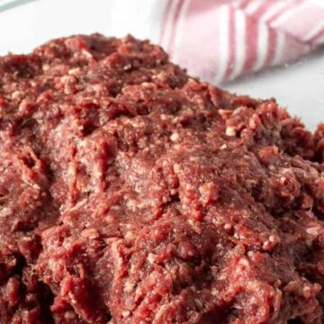A glass bowl filled with ground venison.