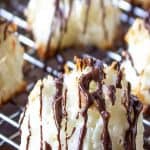 Coconut macaroon drizzled with a thin chocolate sauce across the top of the cookie.