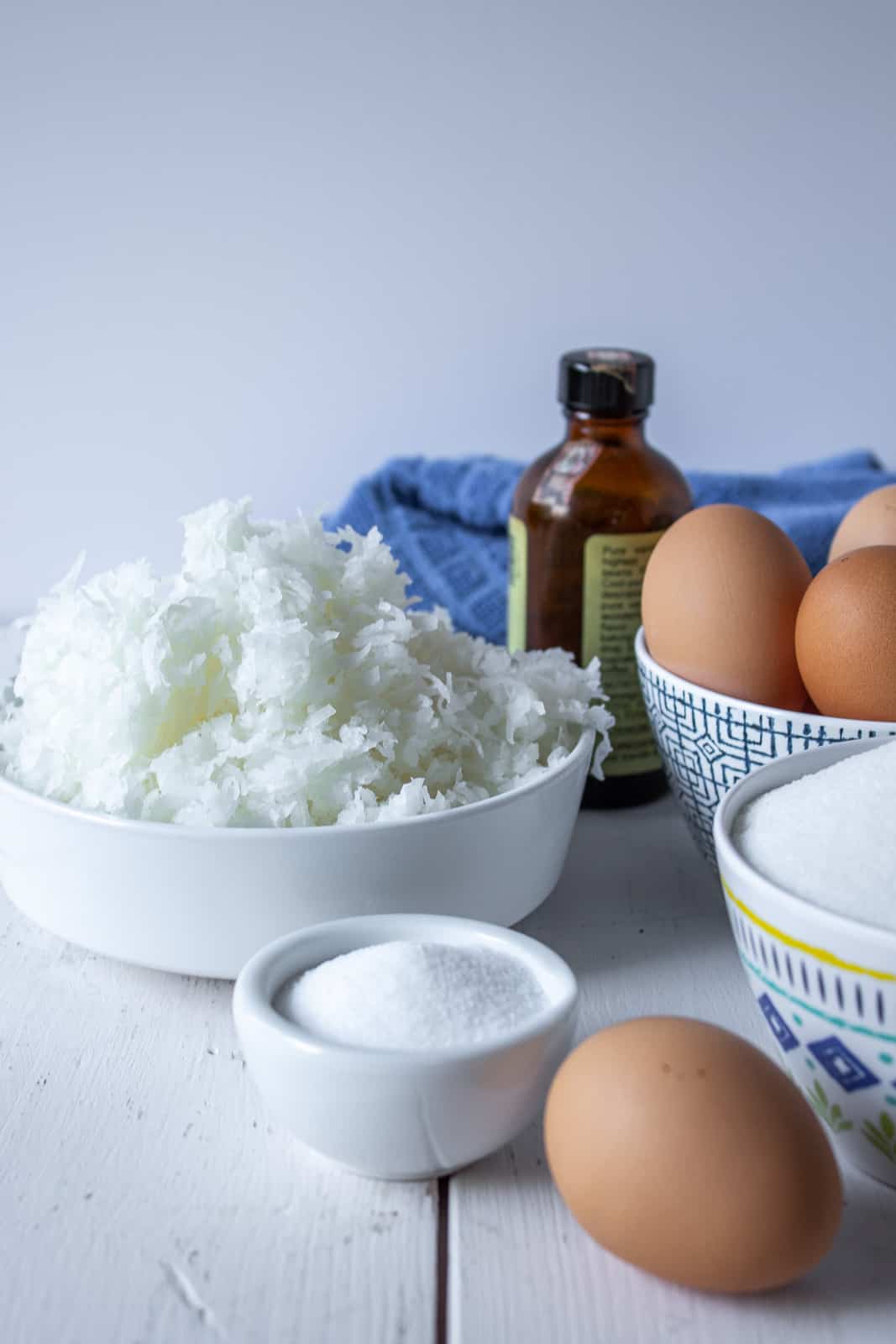 Several small bowls filled with coconut, sugar, and eggs.