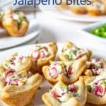 A plate filled with bite sized shells filled with cream cheese and cranberries.