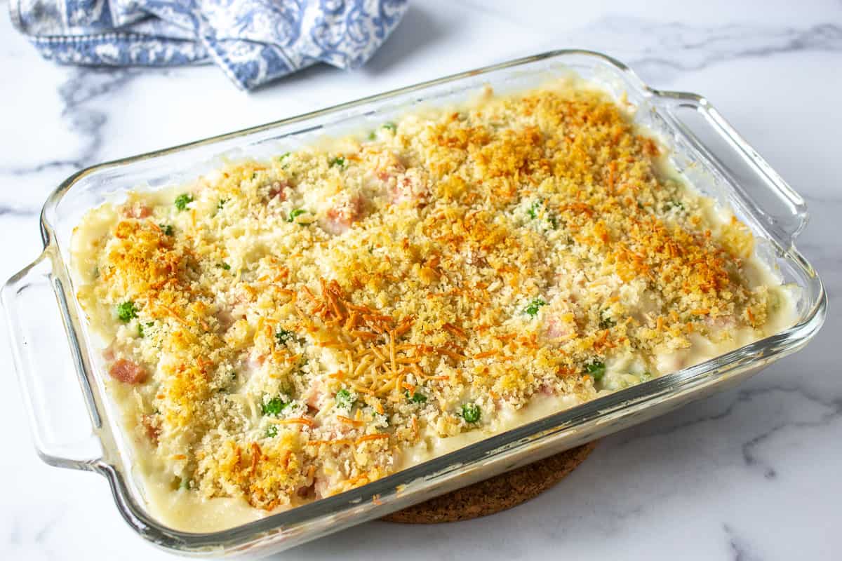 A baked casserole with a golden topping in a glass dish.