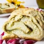 Sliced bread filled with a swirl of pesto and cheese.
