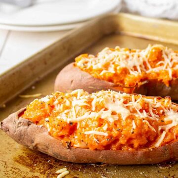 Sweet potato cut in half and filled with mashed sweet potatoes and topped with cheese.