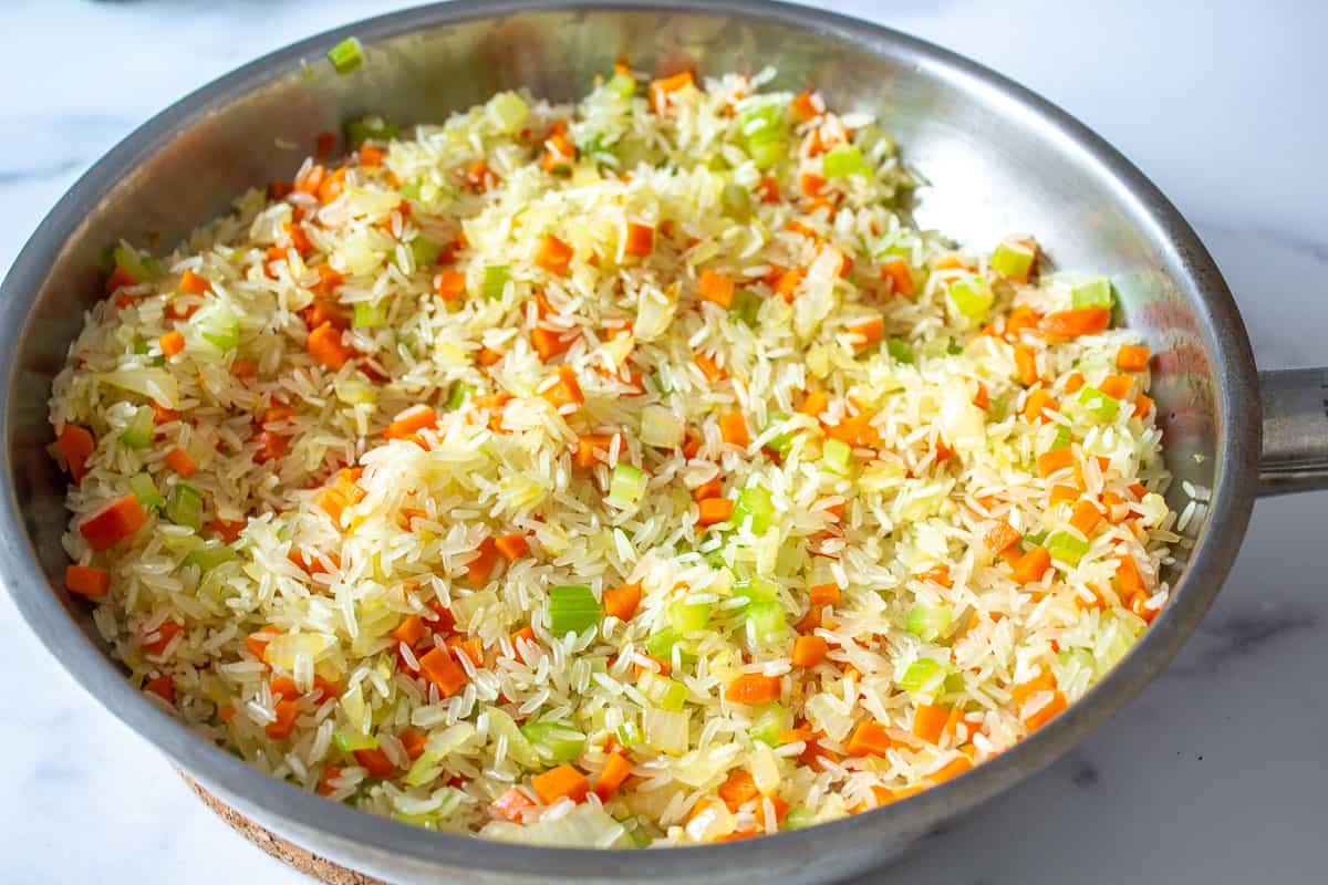 Onions, carrots and celery in a pan.