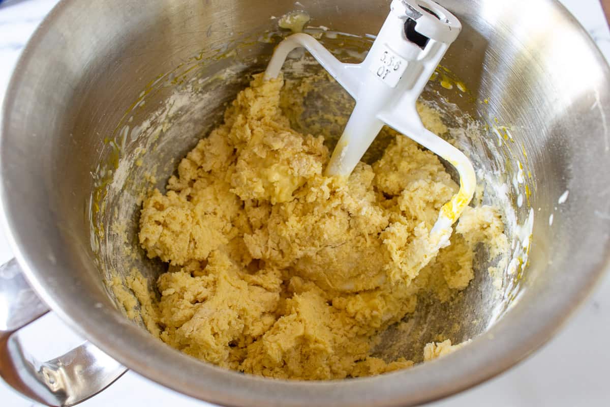 A cakey batter in a mixing bowl.