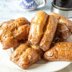 Buttermilk bars piled on a white plate.