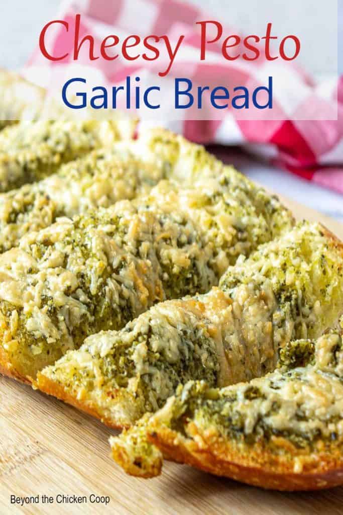 Sliced french bread topped with pesto and cheese.