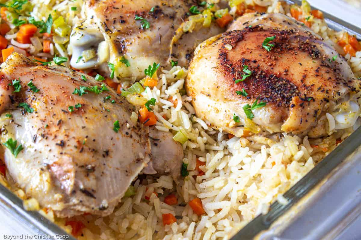 Baked chicken casserole with rice in a glass casserole dish. 
