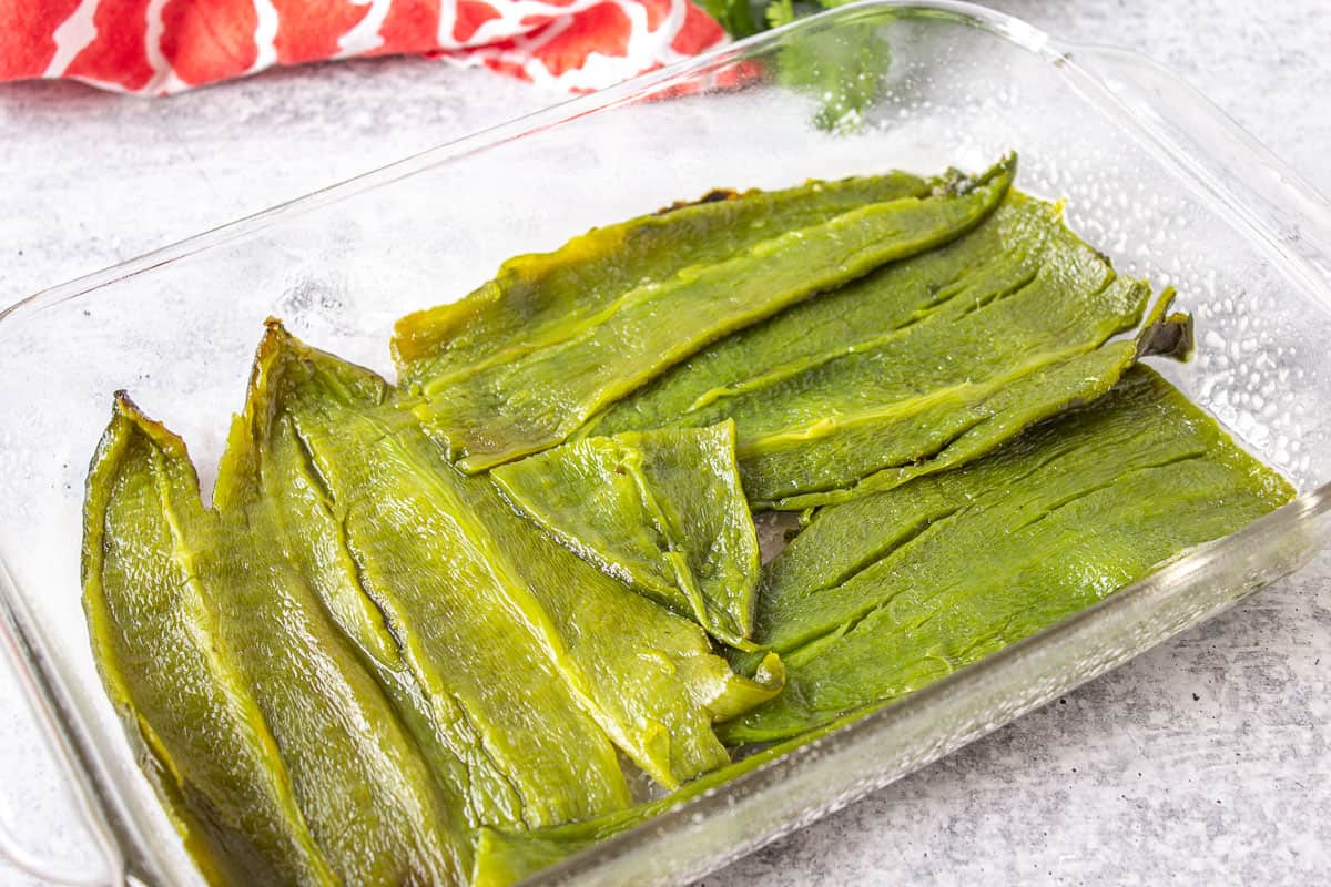 Poblano peppers in a glass casserole dish.