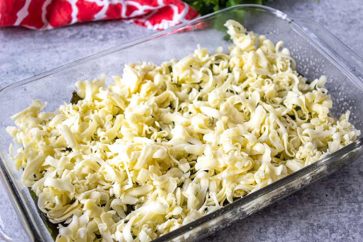 Shredded cheese in a casserole dish.