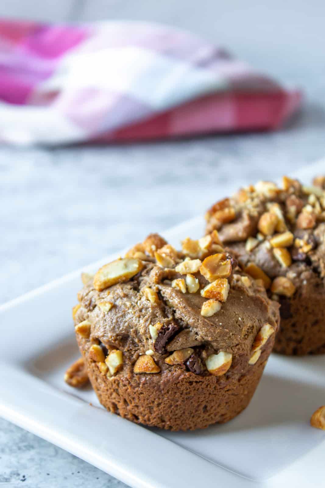 Peanut butter muffins topped with chopped peanuts.