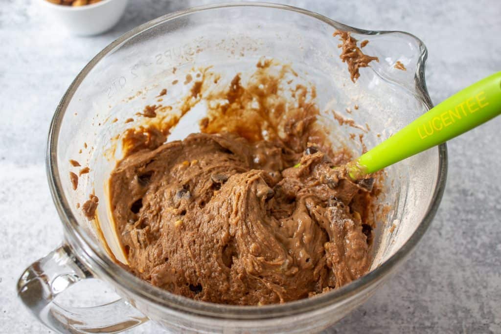 Chocolate muffin mixture in a glass bowl.