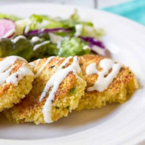 Couscous patties topped with a white drizzle.