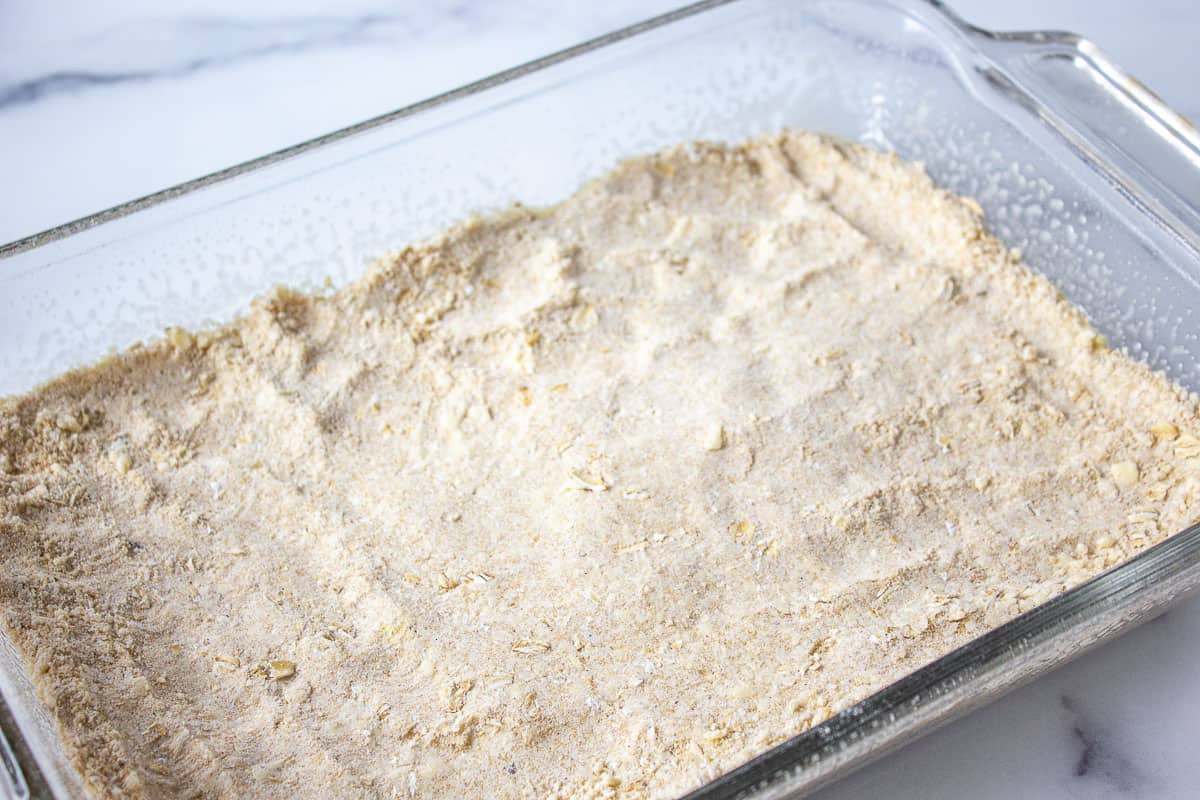 A flour mixture in the bottom of a glass casserole dish.