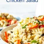 Orzo pasta with chunks of chicken and slices of bell pepper in a bowl.