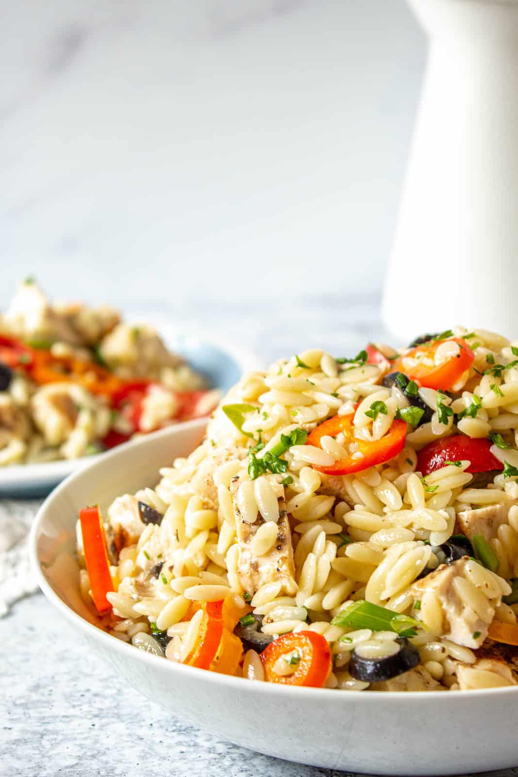 Orzo chicken salad in a large white bowl.