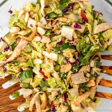 Chopped salad with chicken and almonds in a large bowl.