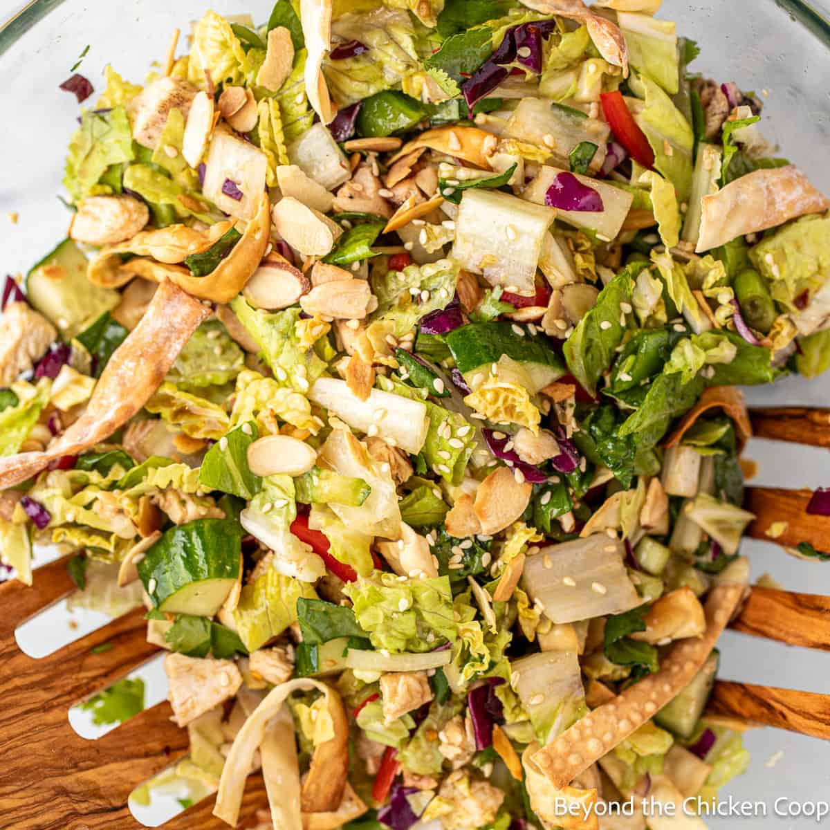 Chopped salad with chicken and almonds in a large bowl. 