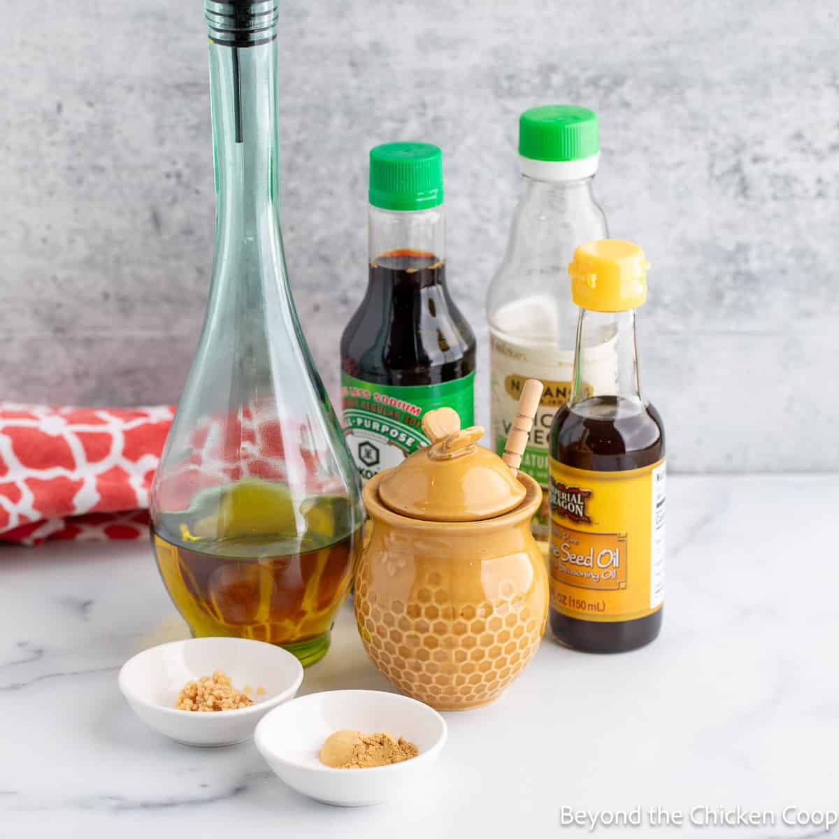 Bottles of soy sauce, oil and vinegar along with honey and garlic. 