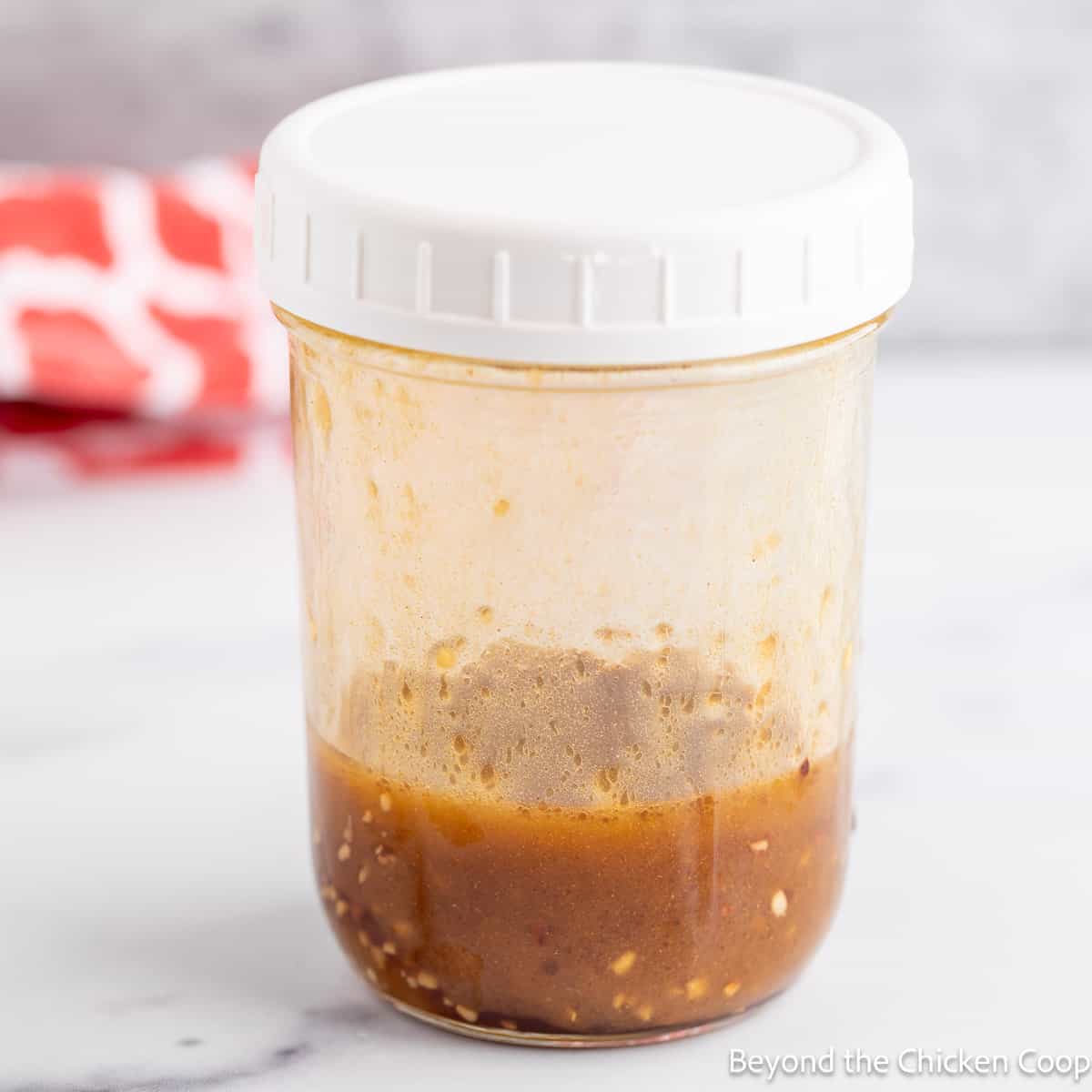 Mixed salad dressing in a jar with a lid. 