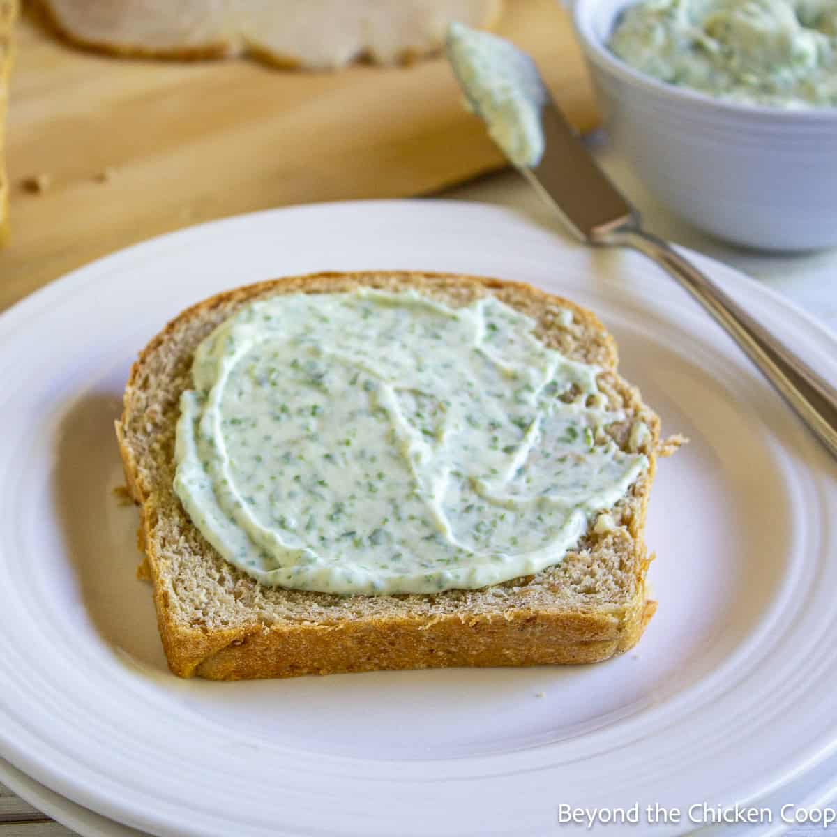 Basil mayonnaise spread on a piece of bread. 