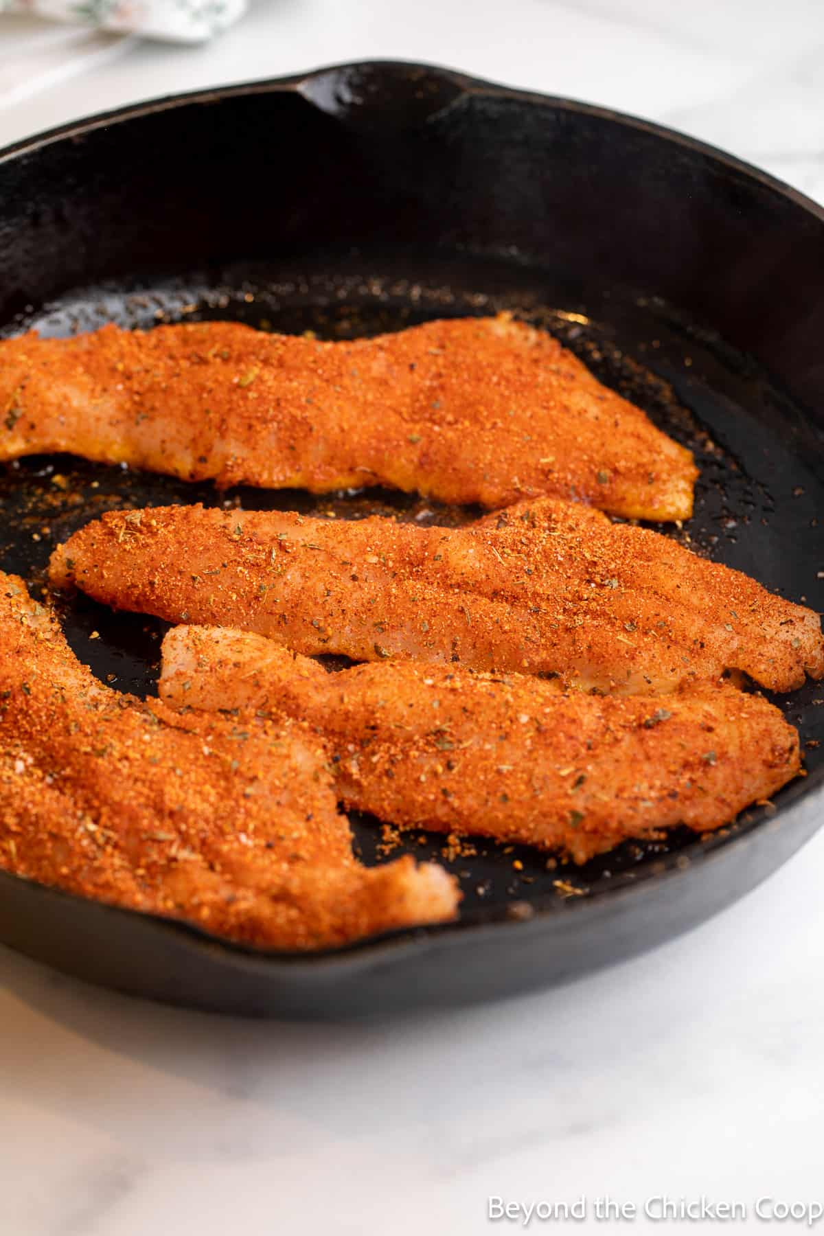 Cooking fillets in a cast iron skillet. 