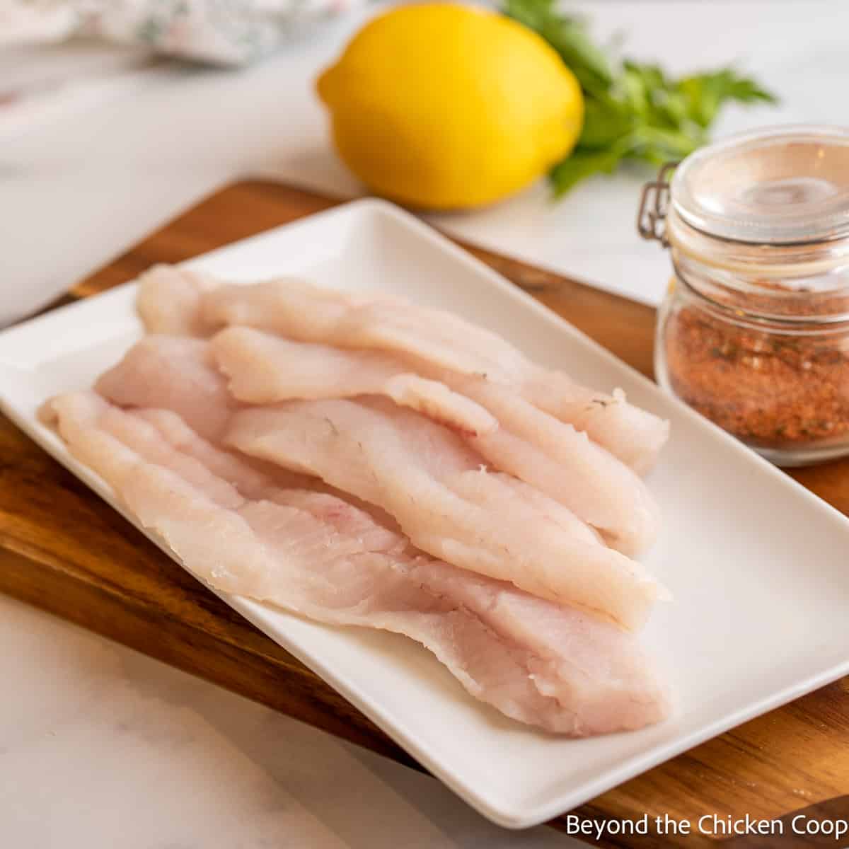 Fillets of walleye on a white platter. 