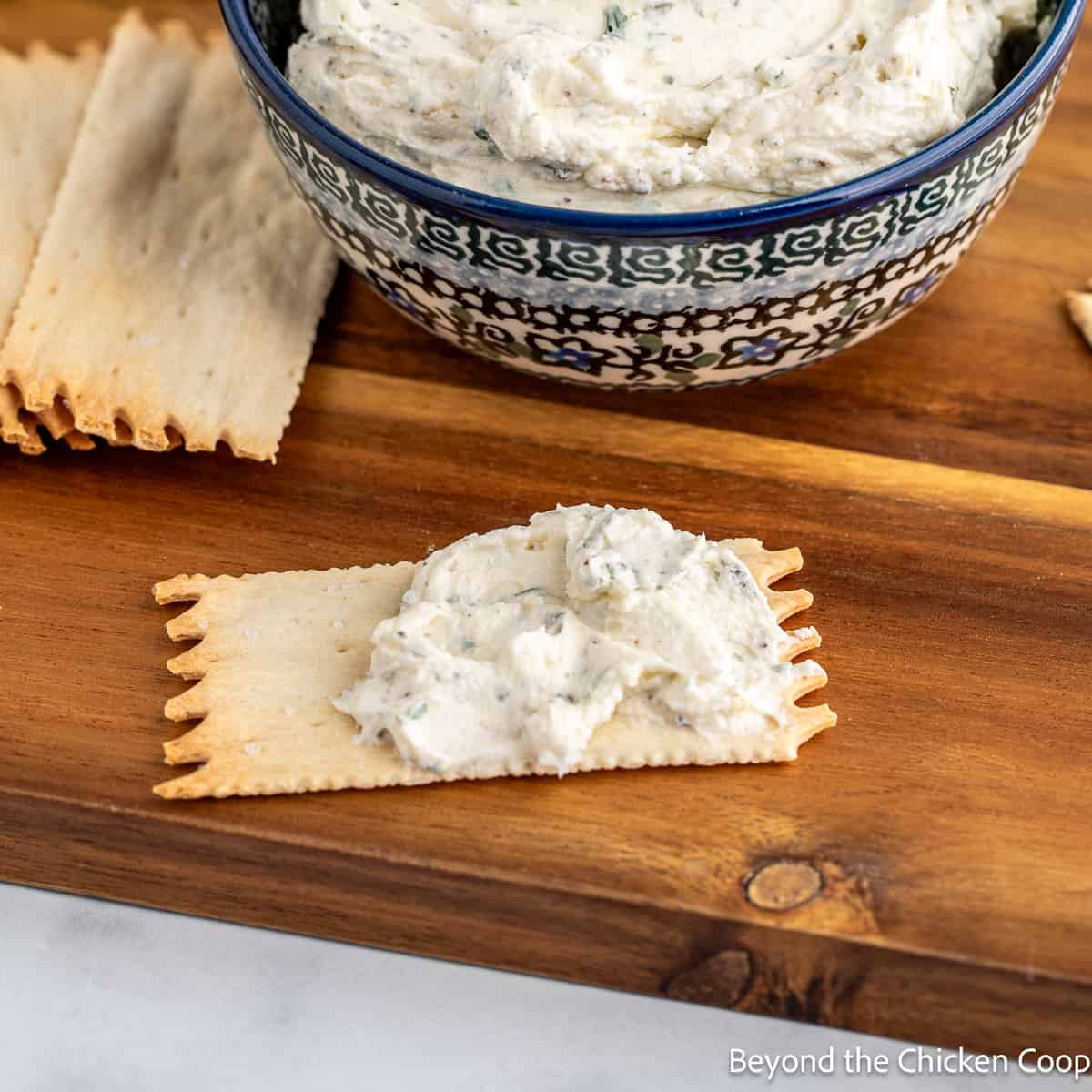 A cracker topped with Boursin cheese.