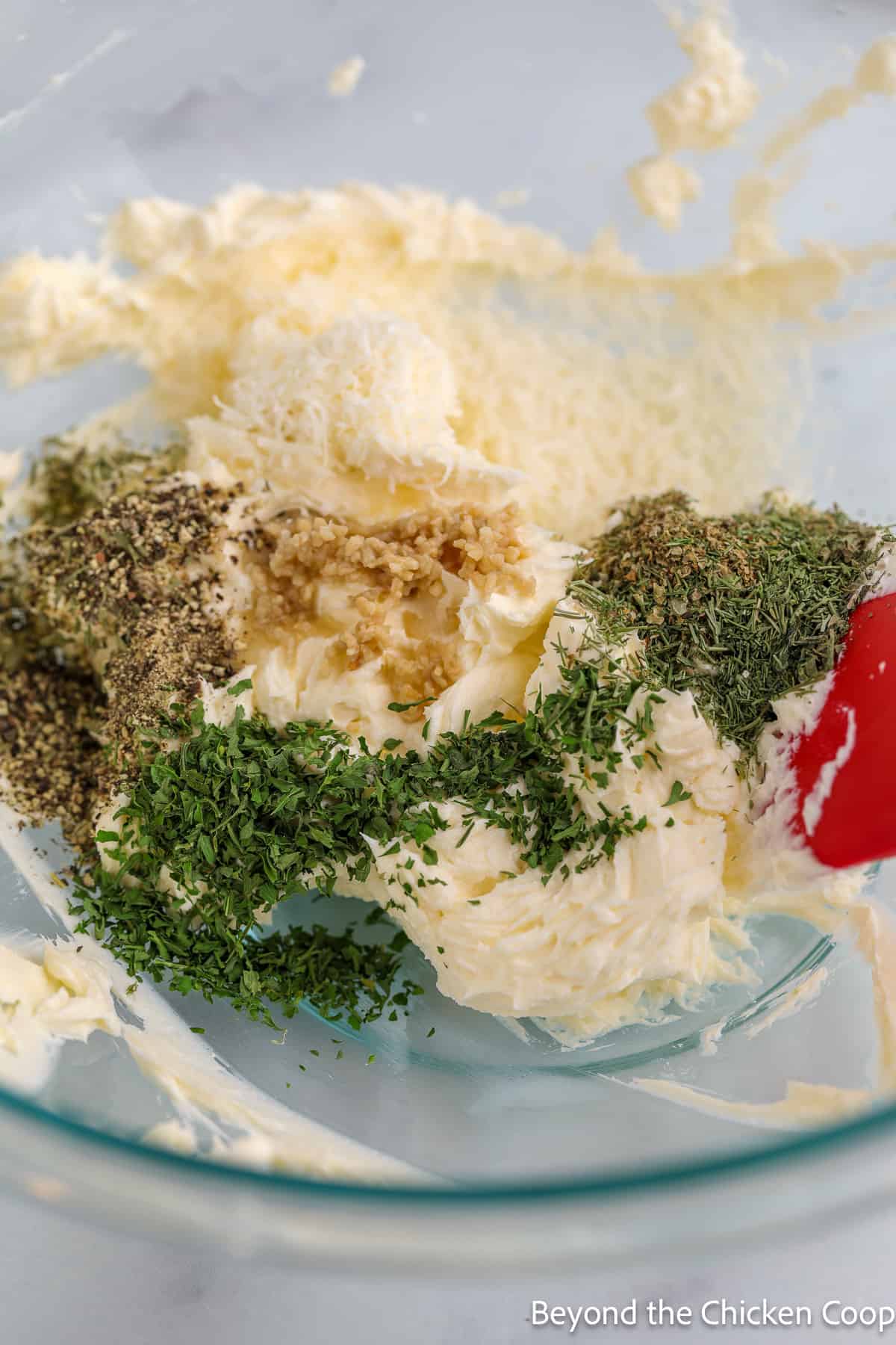 Adding herbs to a creamy mixture. 