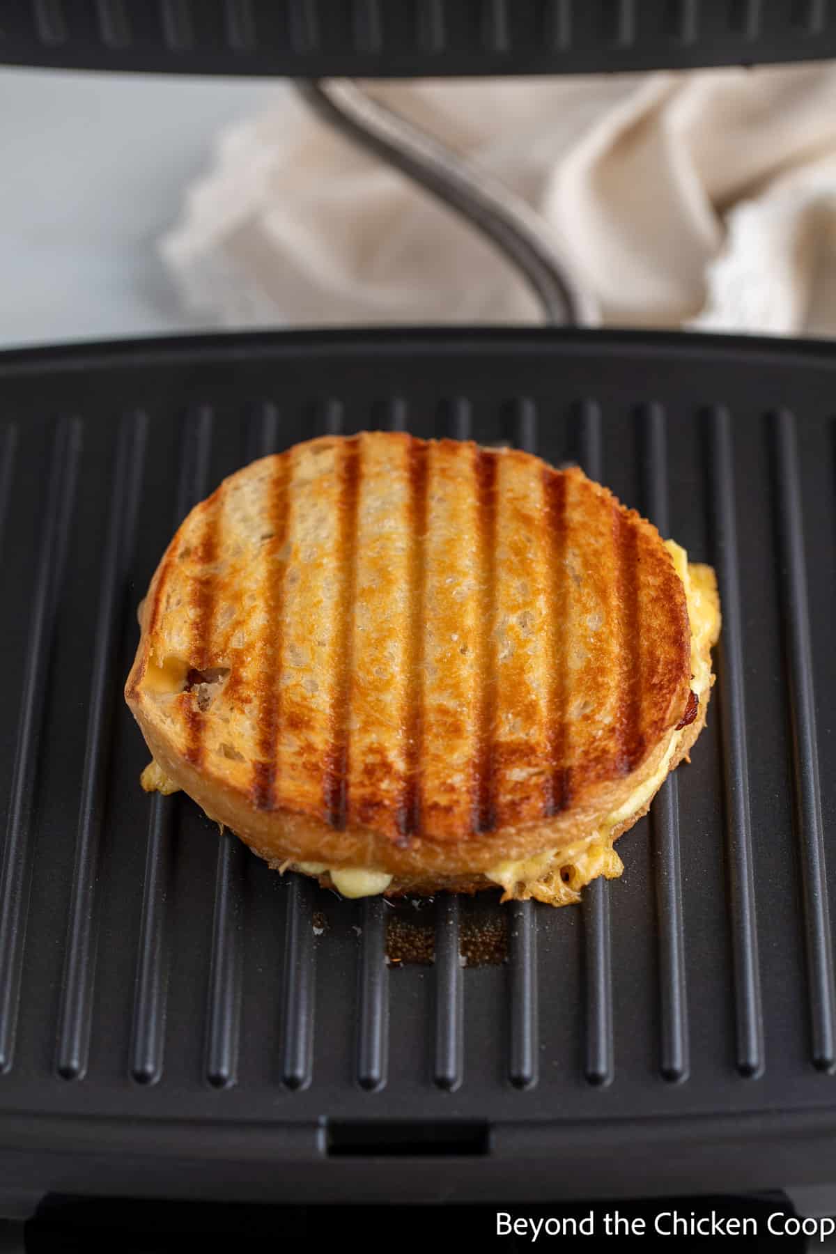 A grilled sandwich on a panini press. 