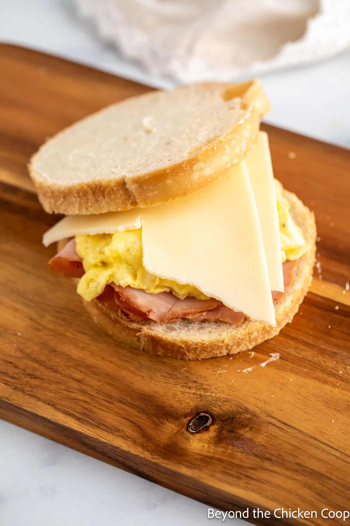 Making a sandwich on a wooden board. 