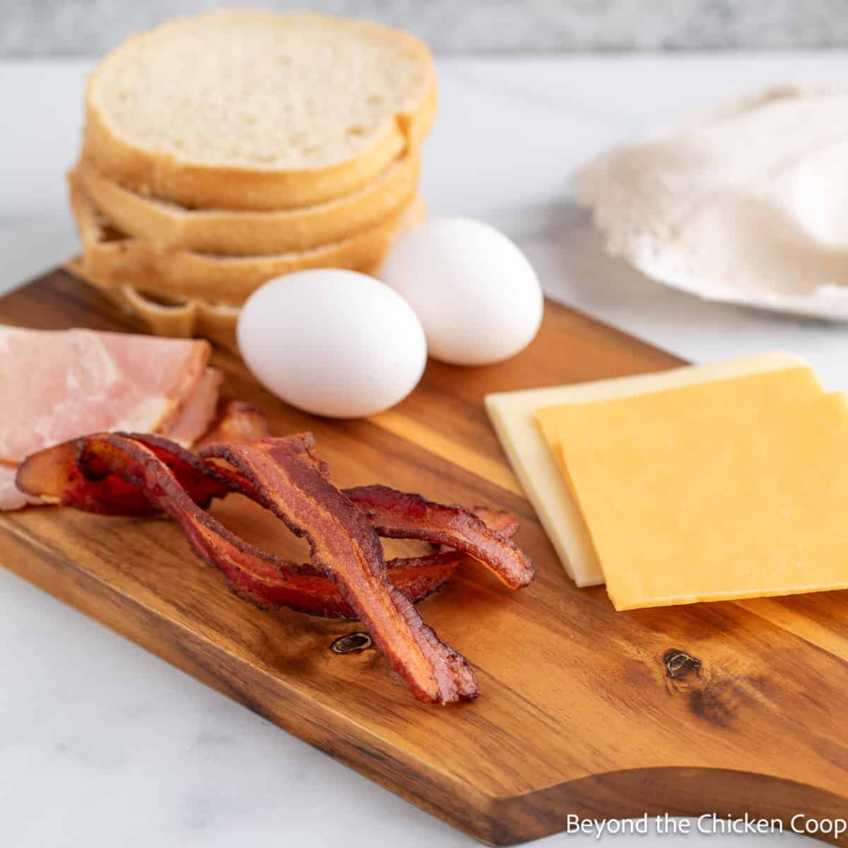 Bacon, cheese and eggs on a wooden board. 