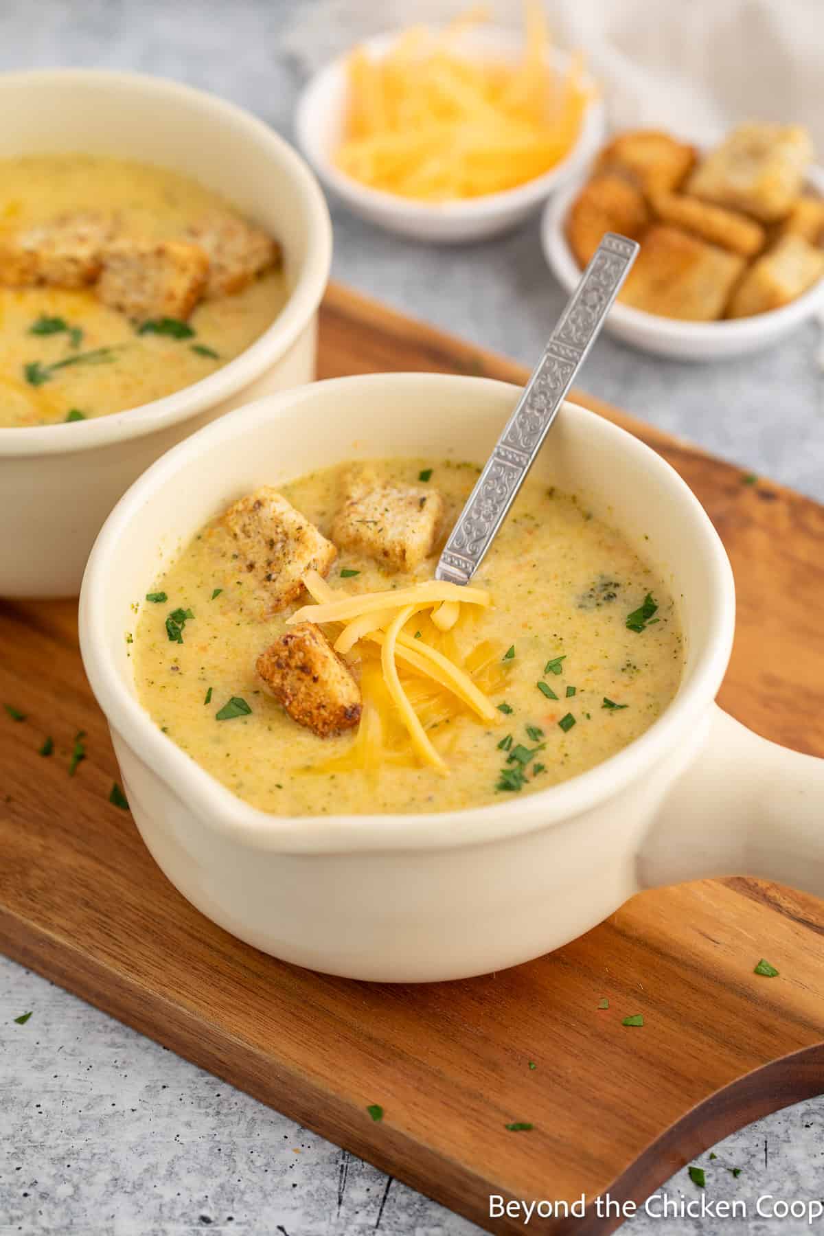 Soup bowls filled with cheesy broccoli soup. 