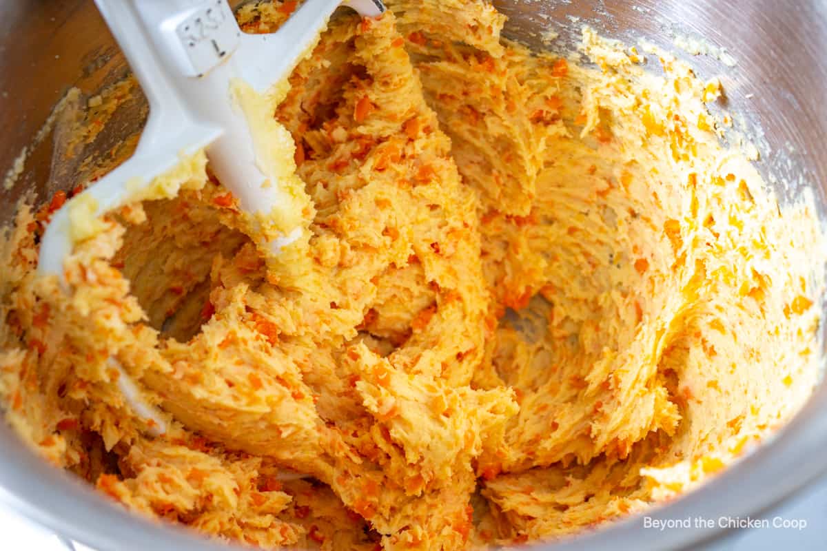 Carrot cookie dough in a mixing bowl.