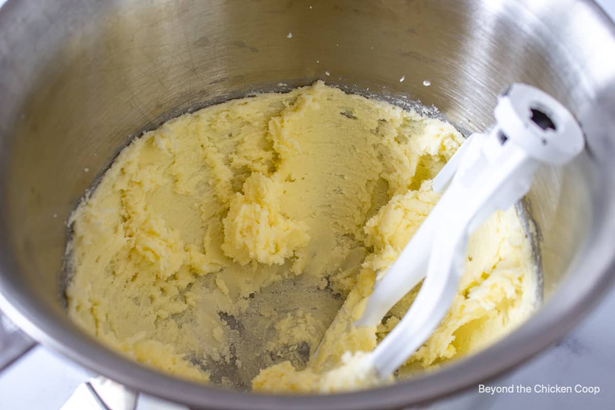 A mixing bowl with a beaten butter mixture.