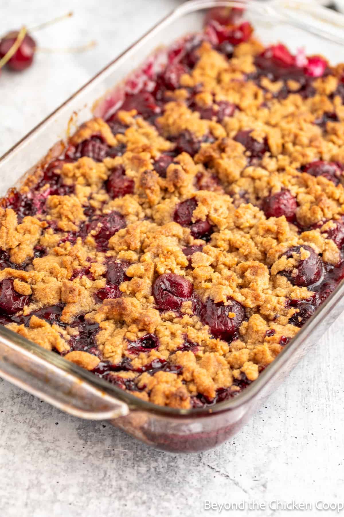 A baked cherry dessert in a casserole dish. 