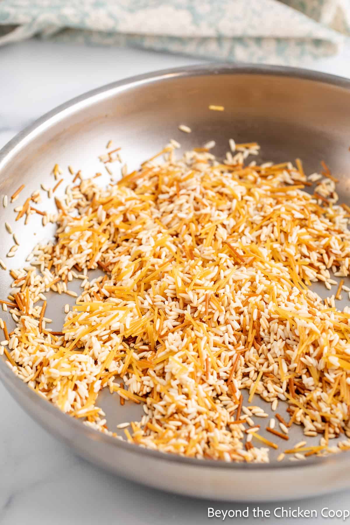 Browned rice and pasta in a pan. 